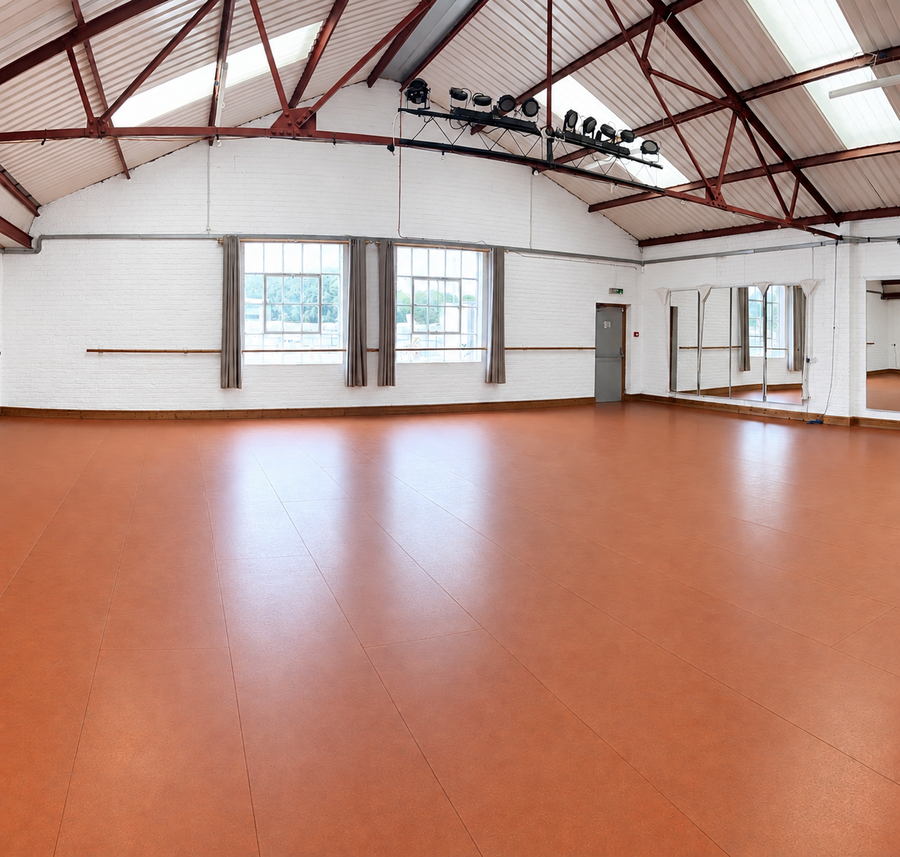 A spacious LHTS dance studio with mirrors, ballet barres and a high ceiling